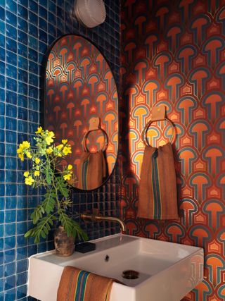 A powder room with 70s style wallpaper