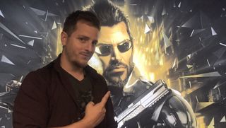 Elias Toufexis pointing at a picture of Adam Jensen