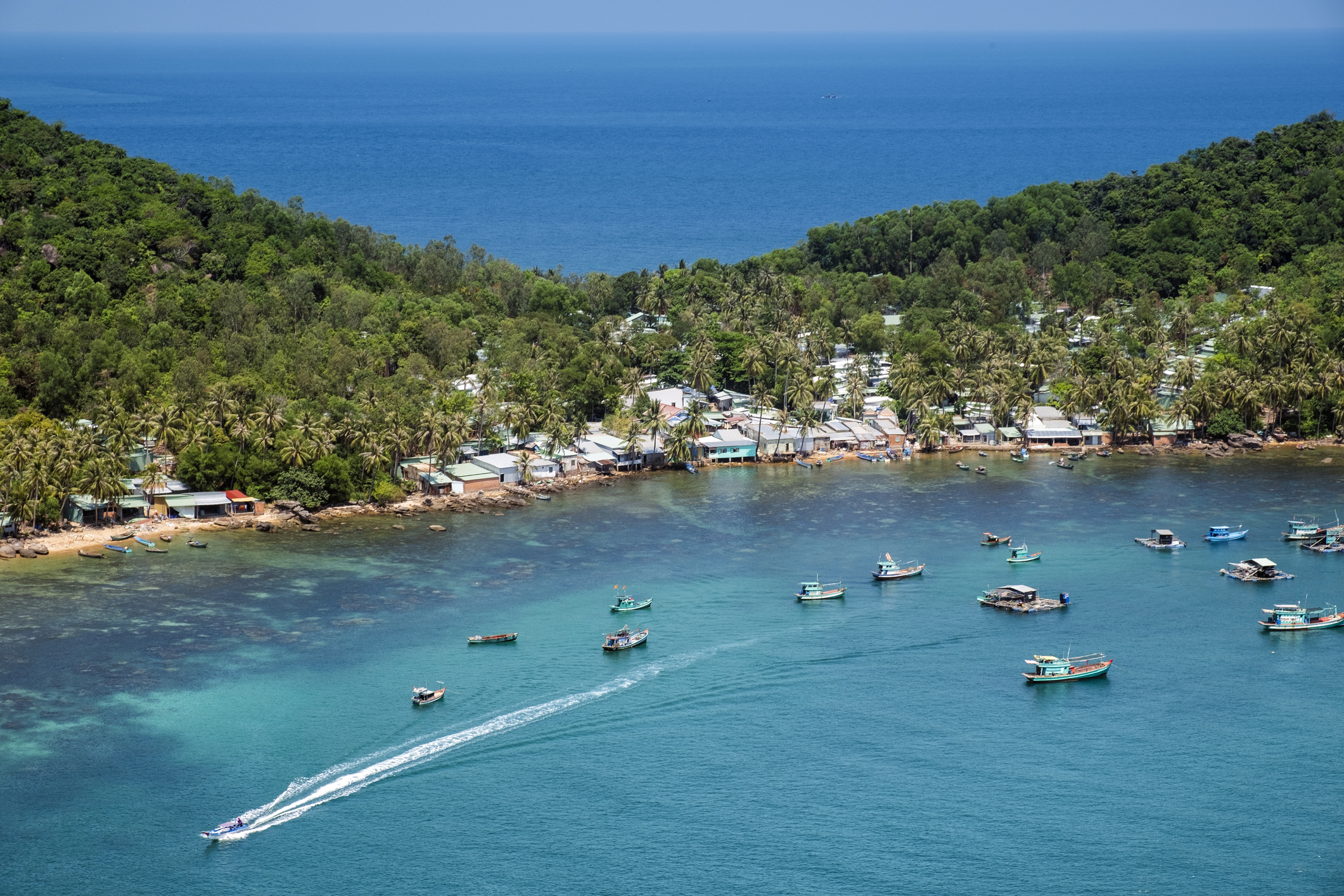 Aerial of a fishing village and a turquoise bay in the Phu Quoc archipelago