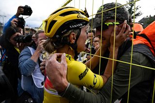 CanyonSRAM Racing teams Polish rider Katarzyna Niewiadoma L embraces her husband Taylor Phinney as she celebrates after crossing the finish line and winning the third edition of the Womens Tour de France cycling race after the 8th and last stage of the Tour de France a 1499 km between Le Grand Bornand and the Alpe dHuez in southeastern France on August 18 2024 Photo by JULIEN DE ROSA AFP Photo by JULIEN DE ROSAAFP via Getty Images