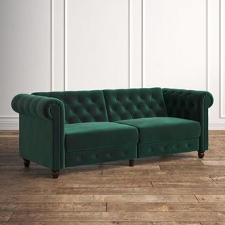 A green upholstered convertible sofa that's a part of Kelly Clarkson's furniture collection.