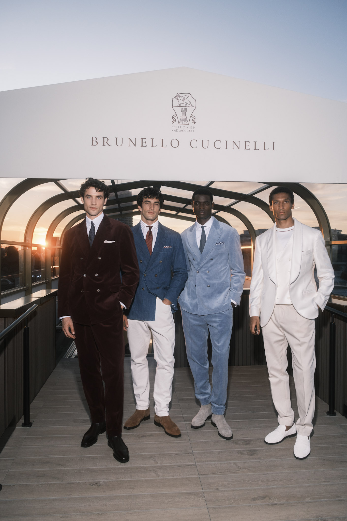 Four male models in tailored suite, posing at sunset on the roof of Harrods