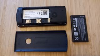 Nokia 110 4G on desk with back cover and battery removed