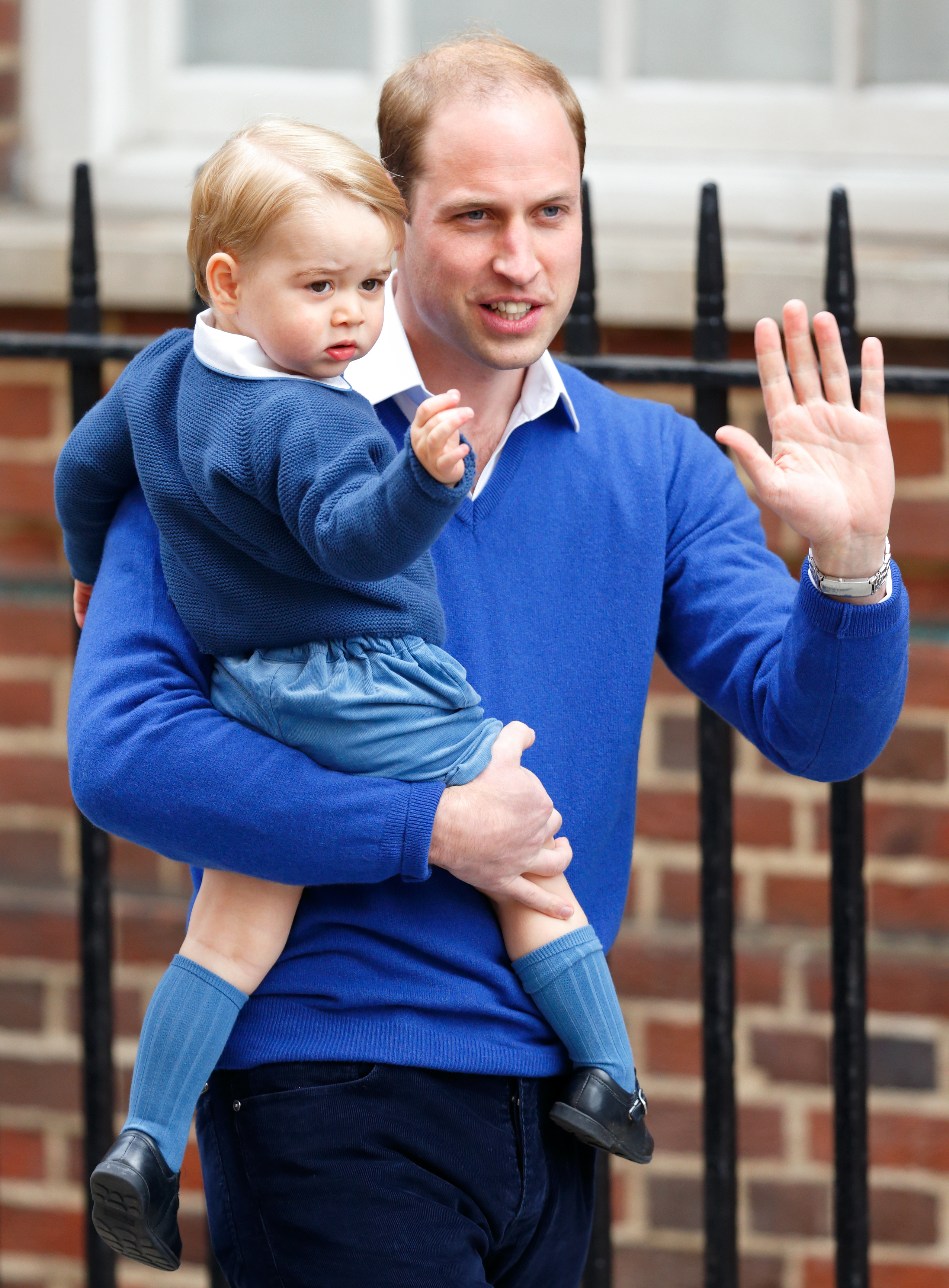 Prince William carries Prince George at the Lindo Wing after Kate Middleton gave birth to Princess Charlotte on May 2, 2015