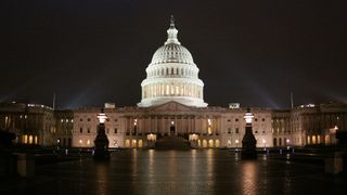 the us capitol building is lit up at night