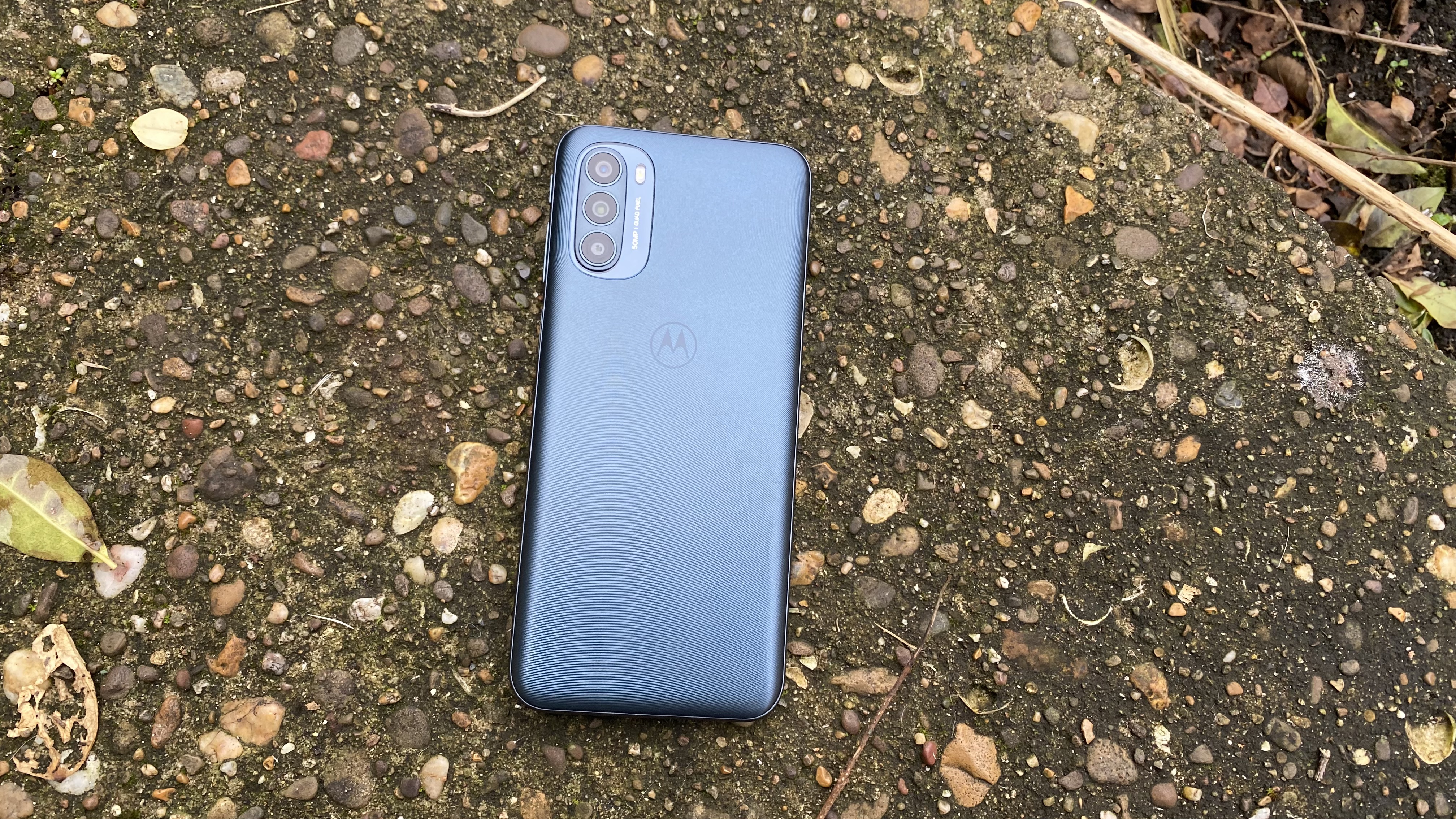 A Moto G31 from the back, outside