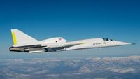 a close-up of a white jet flying through the sky above a snowcapped mountain range