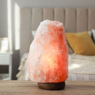 Salt lamp placed on table in bedroom