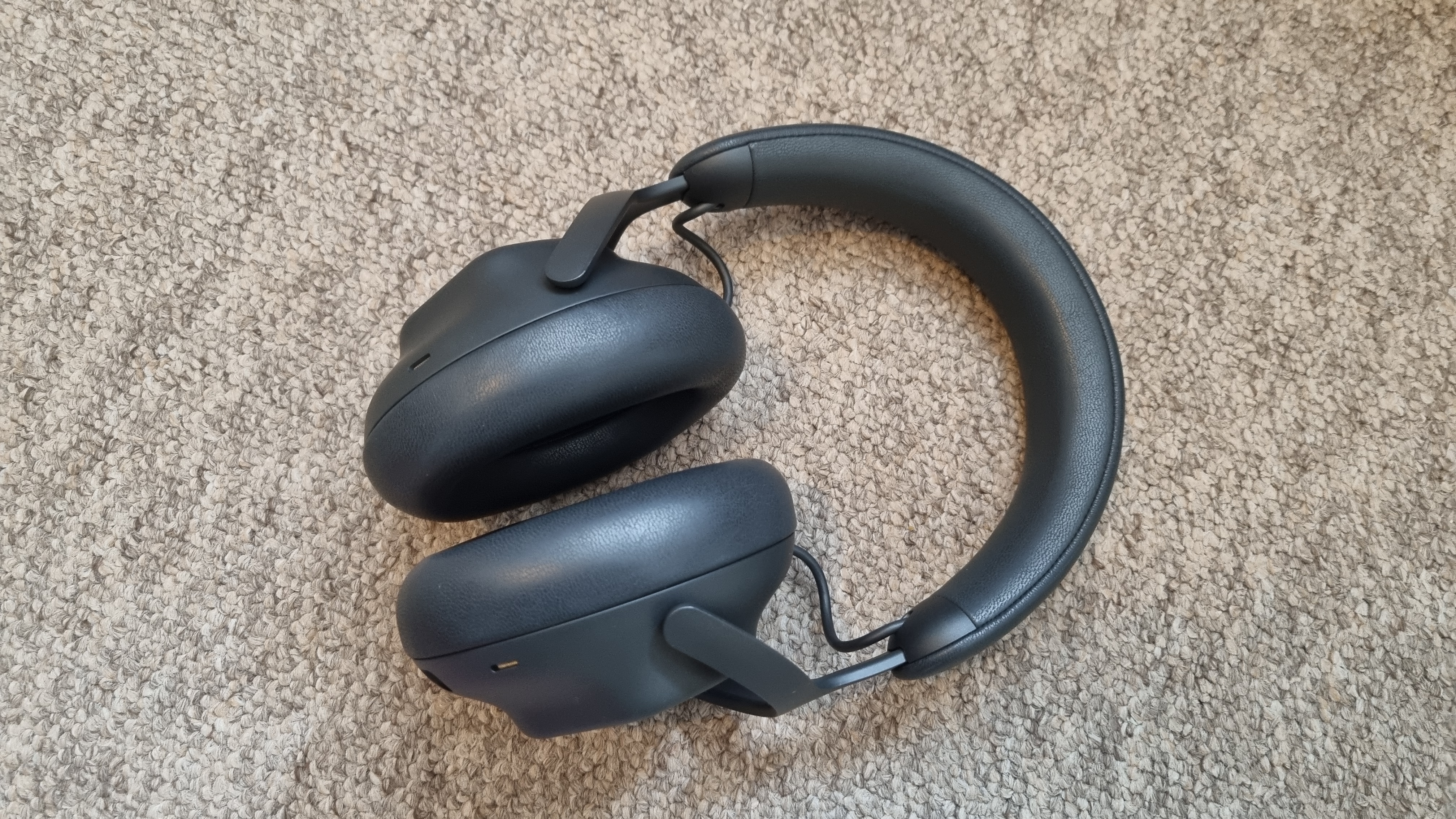 The Alienware Pro Wireless gaming headset from above on a neutral, carpeted background.