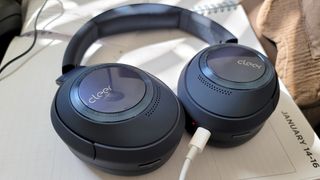 The Cleer Audio Alpha headphones being charged