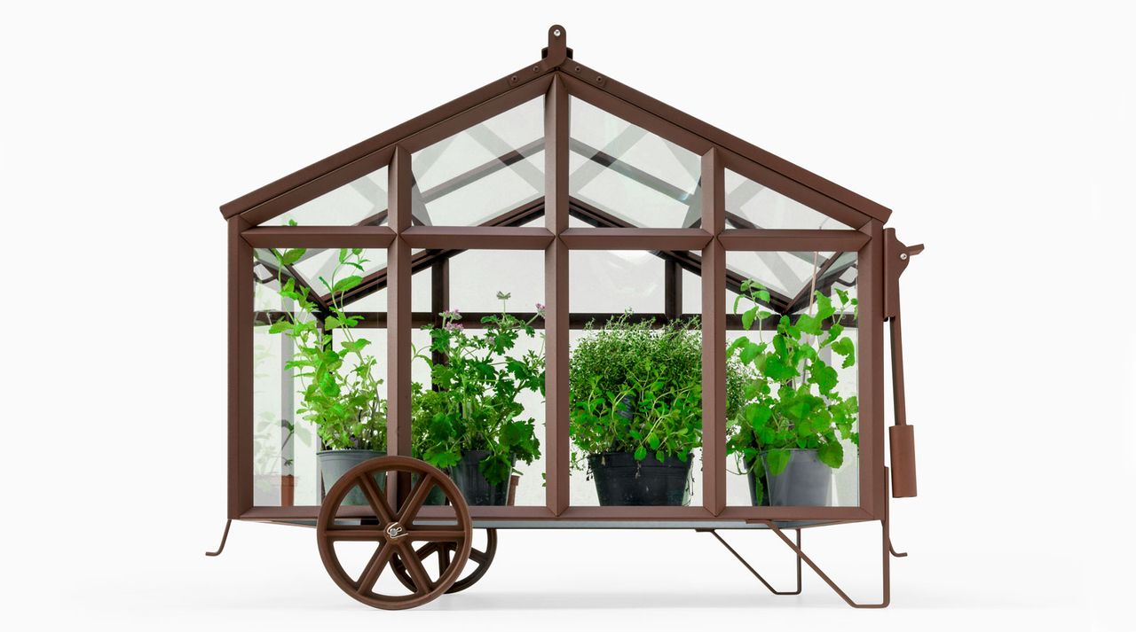 Small iron greenhouse with a wheel and plants in it, ‘Bramber’ from Revised