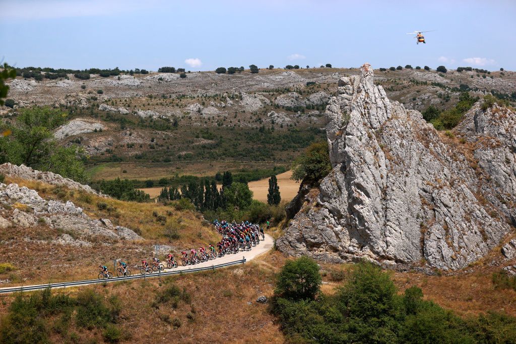 VILLADIEGO SPAIN AUGUST 03 A general view of the peloton passing through a landscape during the 44th Vuelta a Burgos 2022a Stage 2 a 158km stage from Vivar del Cid to Villadiego on August 03 2022 in Villadiego Spain Photo by Gonzalo Arroyo MorenoGetty Images