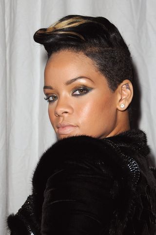 Rihanna has a short hairstyle with honey highlights as she poses backstage during the Givenchy Pret a Porter show as part of the Paris Womenswear Fashion Week Spring/Summer 2010 on October 4, 2009 in Paris, France.