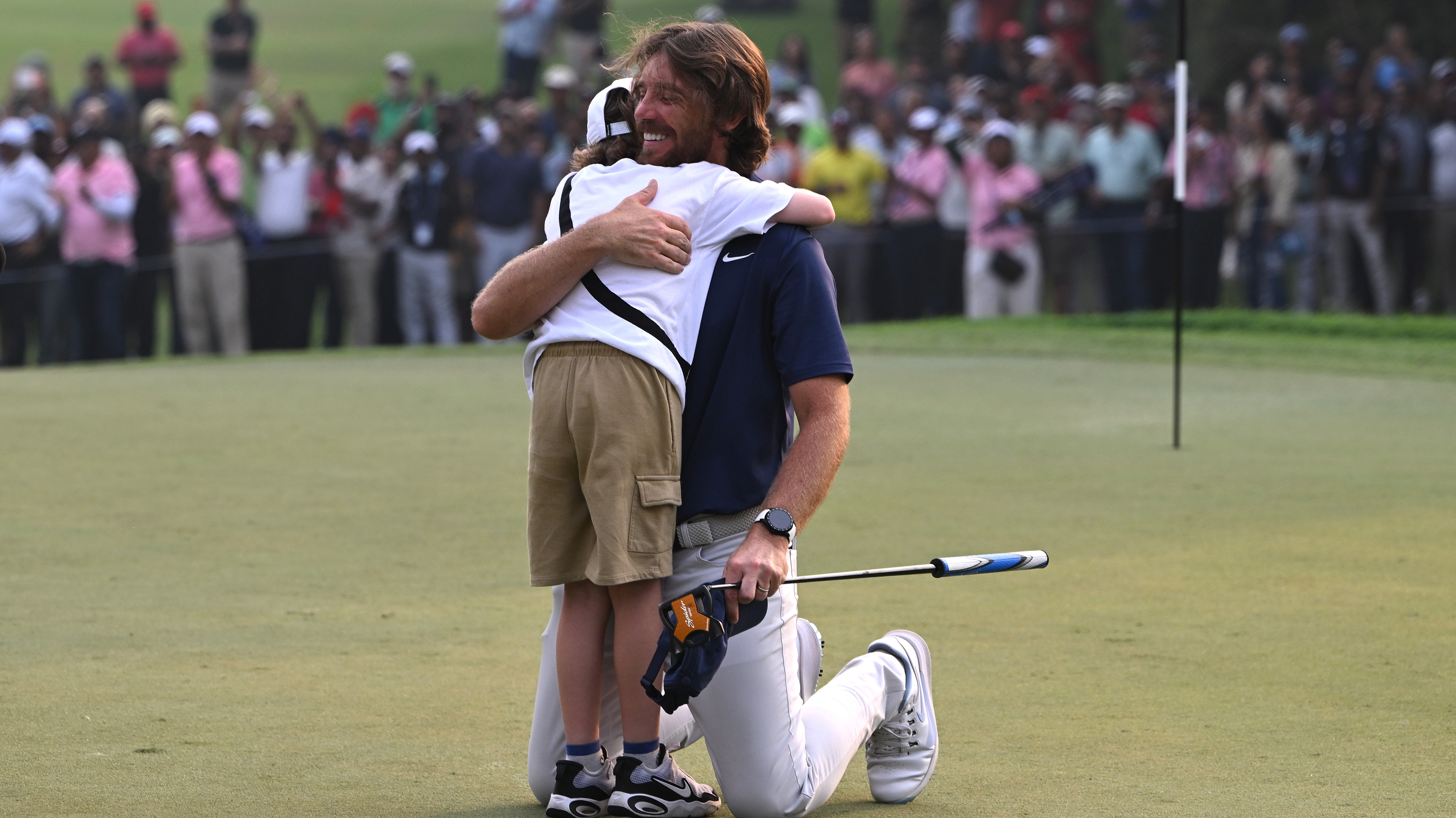 Tommy Fleetwood of England (R) celebrates with, his son, Frankie Fleetwood (L) following victory on day four of the DP World India Championship 2025 at Delhi Golf Club on October 19, 2025 in New Delhi, India.