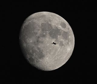 The Moon Waxing Gibbous with an airliner flying across the Moon . Picture taken in Swindon, Wiltshire, England on the 24th of November 2023.