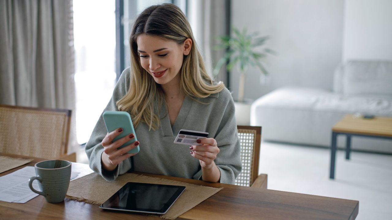 Woman shopping on phone with credit card