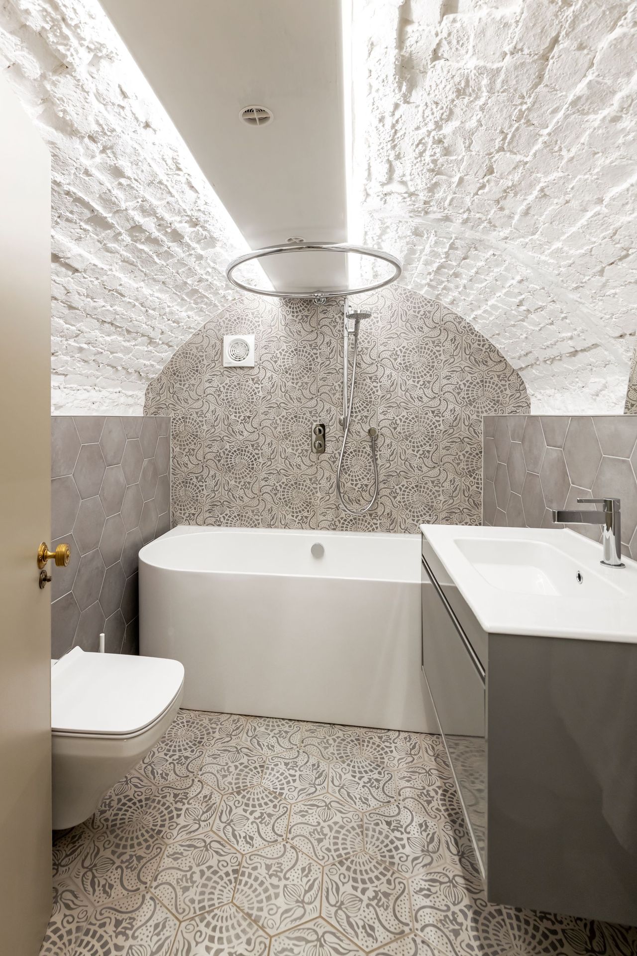 Bathroom with tiled walls and a curved ceiling