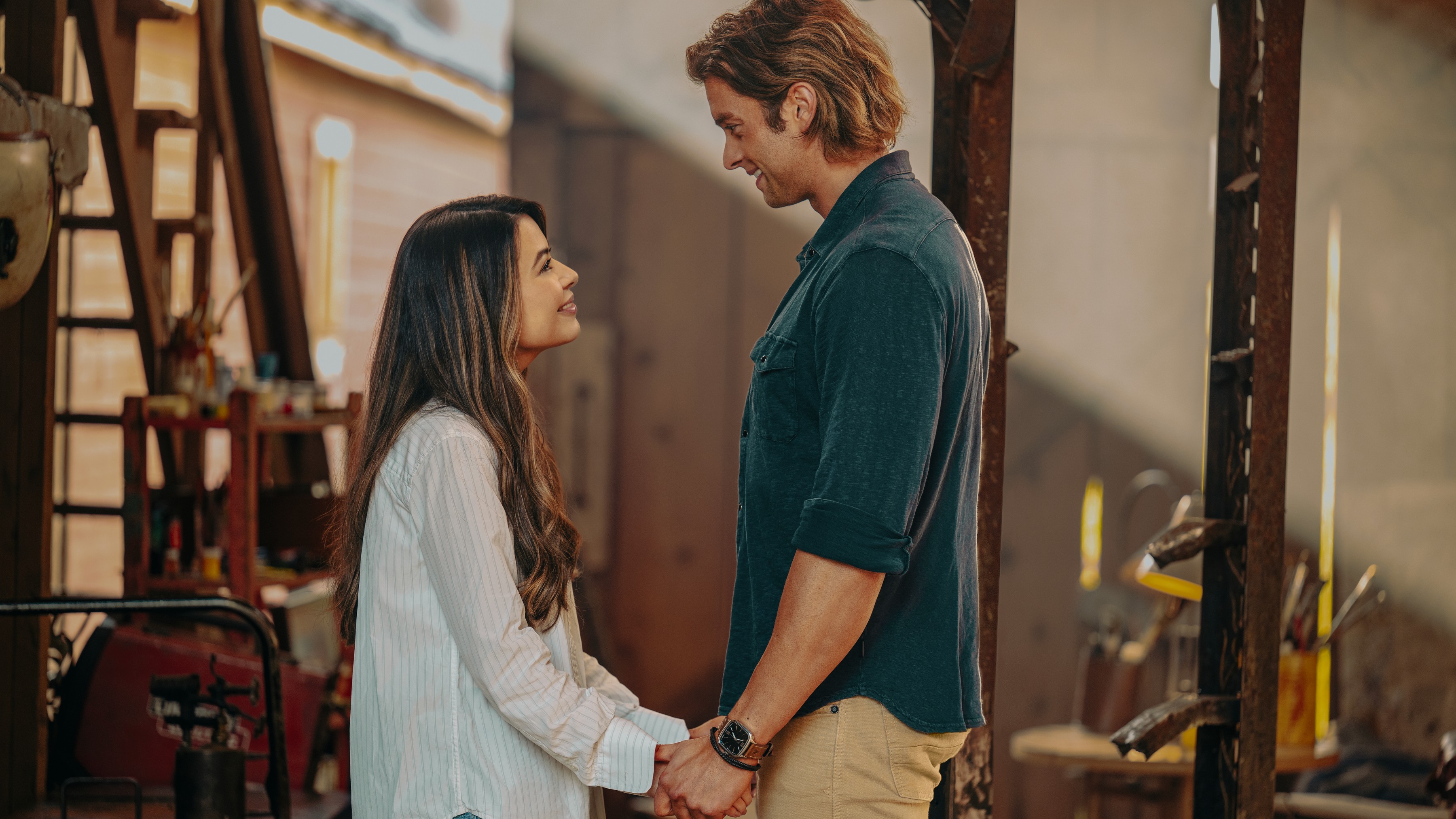 L-R: Dawn (Miranda Cosgrove) and Trey (Pierson Fodé) hold hands in a scene from Netflix's "The Wrong Paris"