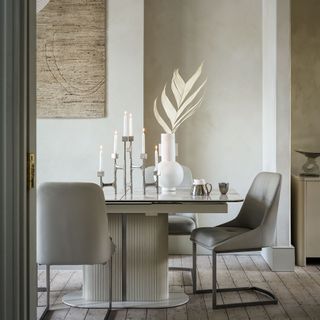 Neutral dining room with chairs around table with ribbed base