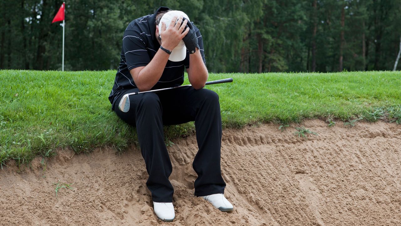 golfer with his head in his hands