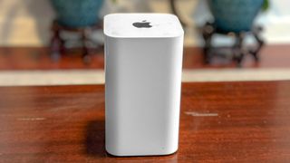 A straight-on shot of an Apple AirPort Extreme base station on a table