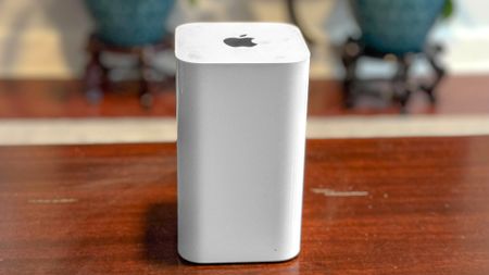 A straight-on shot of an Apple AirPort Extreme base station on a table