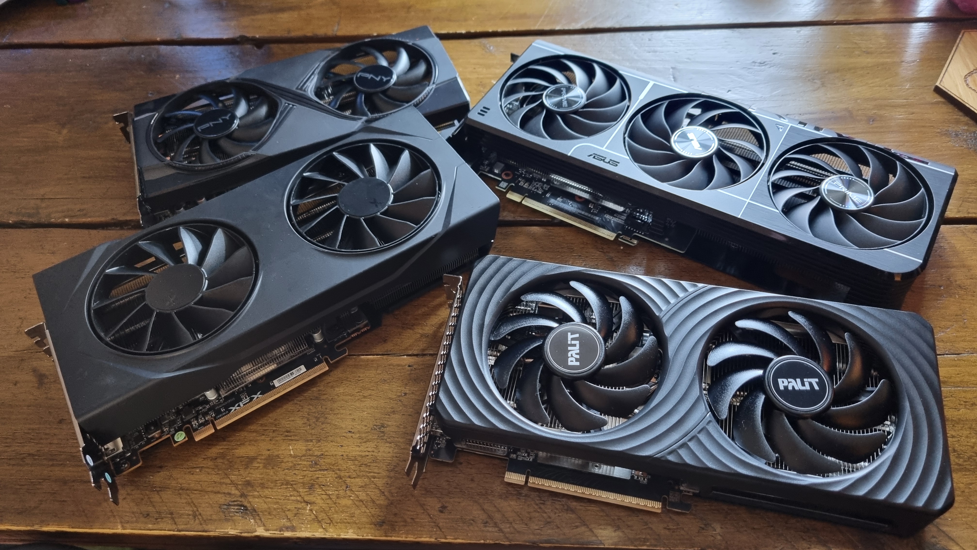 Four budget graphics cards arranged tastefully on a wooden desk