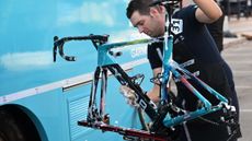 World Tour Bike mechanic for the Astana XDS X-Lab race team, washing and cleaning down one the teams race bikes. 