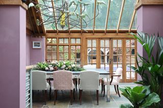 pink conservatory interior design with timber framed glazing