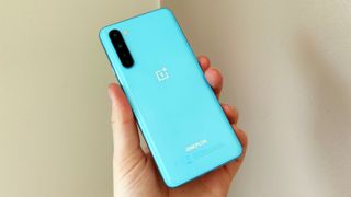 A OnePlus Nord in blue, in someone's hand