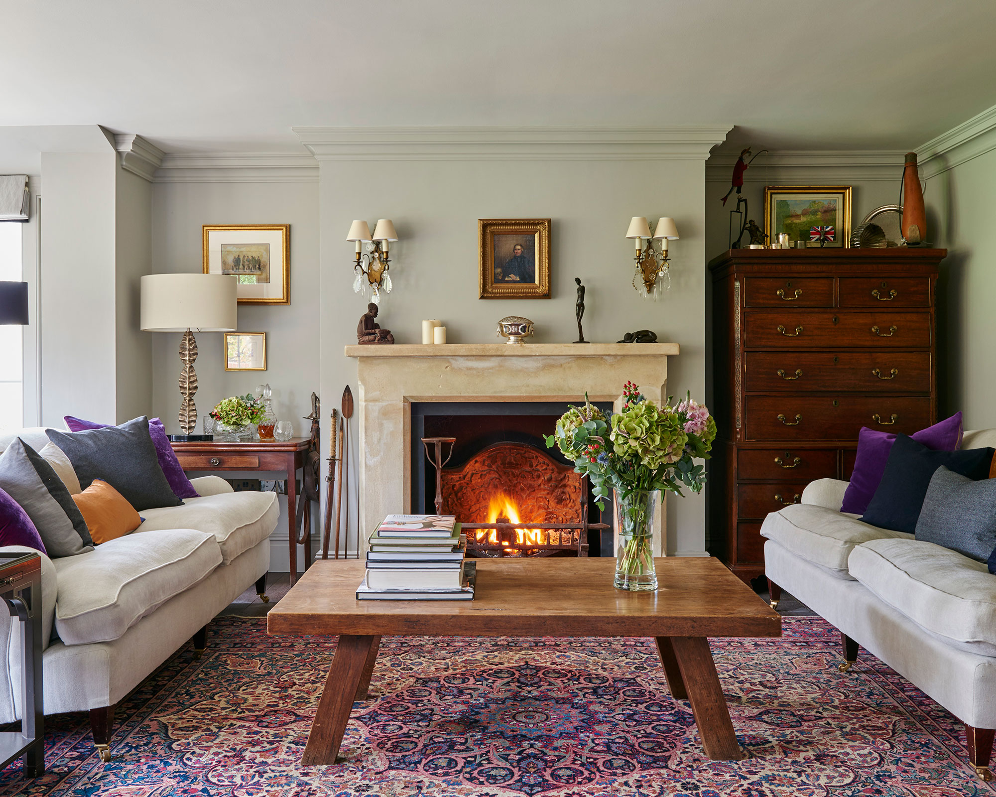 Living room with fire, rug and traditional armchairs