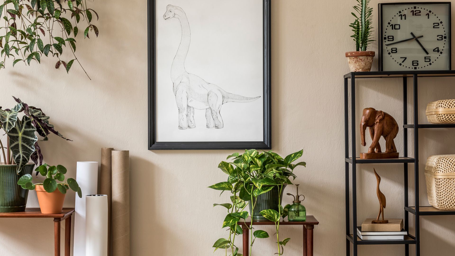 beige living room wall with metal open shelving unit, sideboard and plants used by a home stager to solve how to make a small living room look bigger