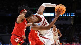 Brandon Miller #24 of the Alabama Crimson Tide drives against Ian Martinez #23 of the Maryland Terrapins during the second half in the second round of the NCAA Men's March Madness Basketball Tournament at Legacy Arena