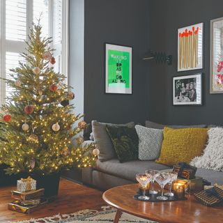 A living room with a decorated Christmas tree