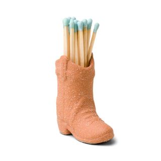 Terracotta brown cowboy boot holding matches
