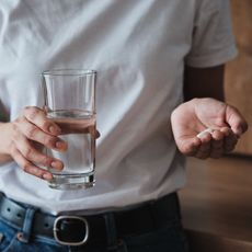 Probiotics for women: Young woman talking supplement 