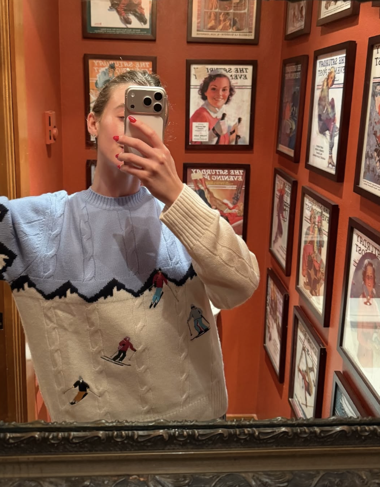 Woman wearing a retro ski sweater.