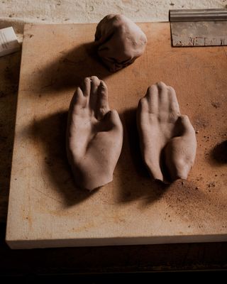 Castings of hands on workbench