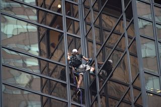 A man climbs up the side of Trump Tower Wednesday.