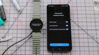 Samsung Galaxy Watch 7 next to a Samsung Galaxy S24 smartphone showing advanced sleep tracking options