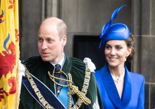 Prince William wears green velvet robes and Kate Middleton wears a royal blue jacket and matching hat