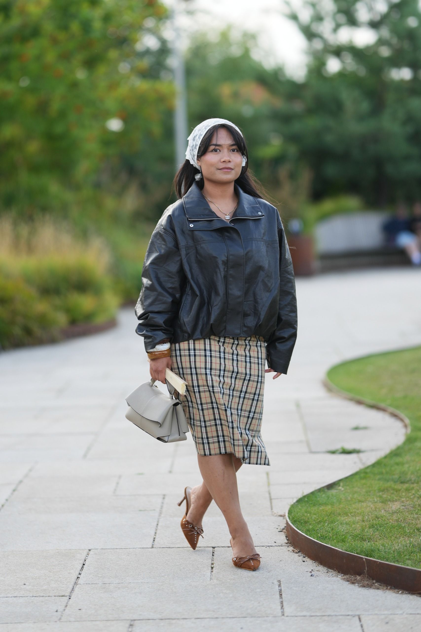 woman in leather jacket plaid scarf
