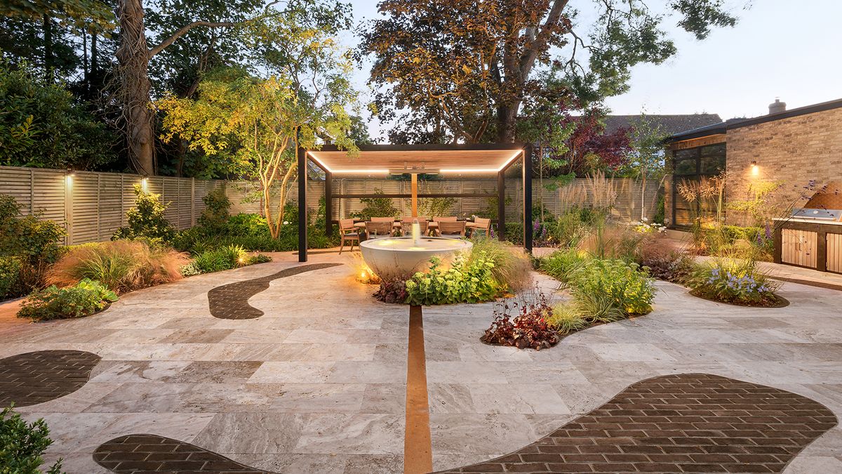 this small london garden has plenty of garden lighting ideas with a covered pergola and fence lights