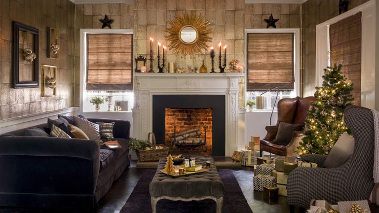Christmas fireplace decor with gold candles, wallpaper and mirror
