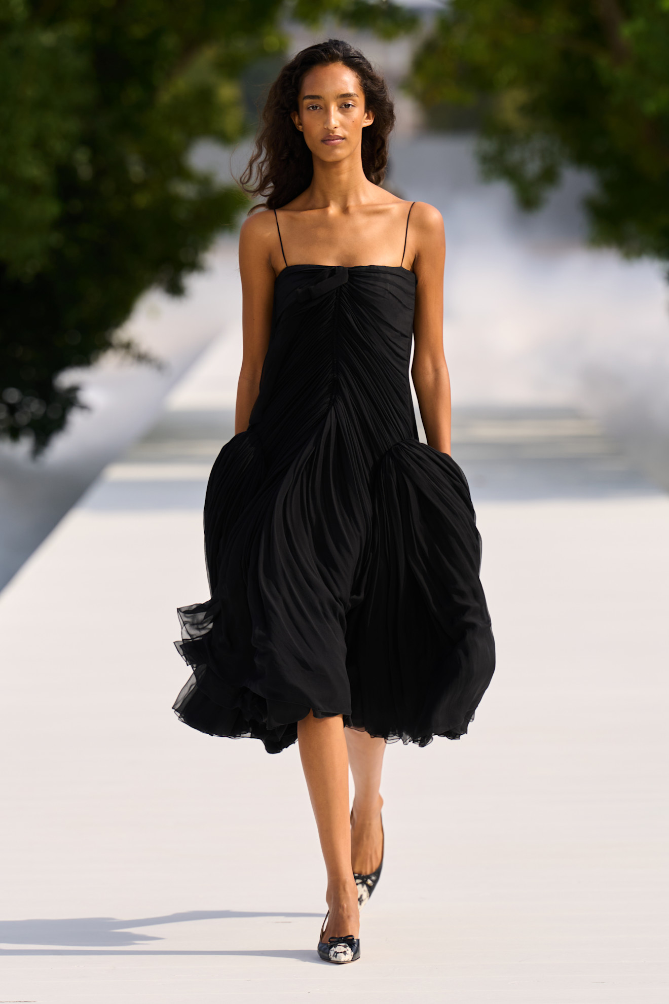 a woman wears a peplum dress at dior spring 2027.
