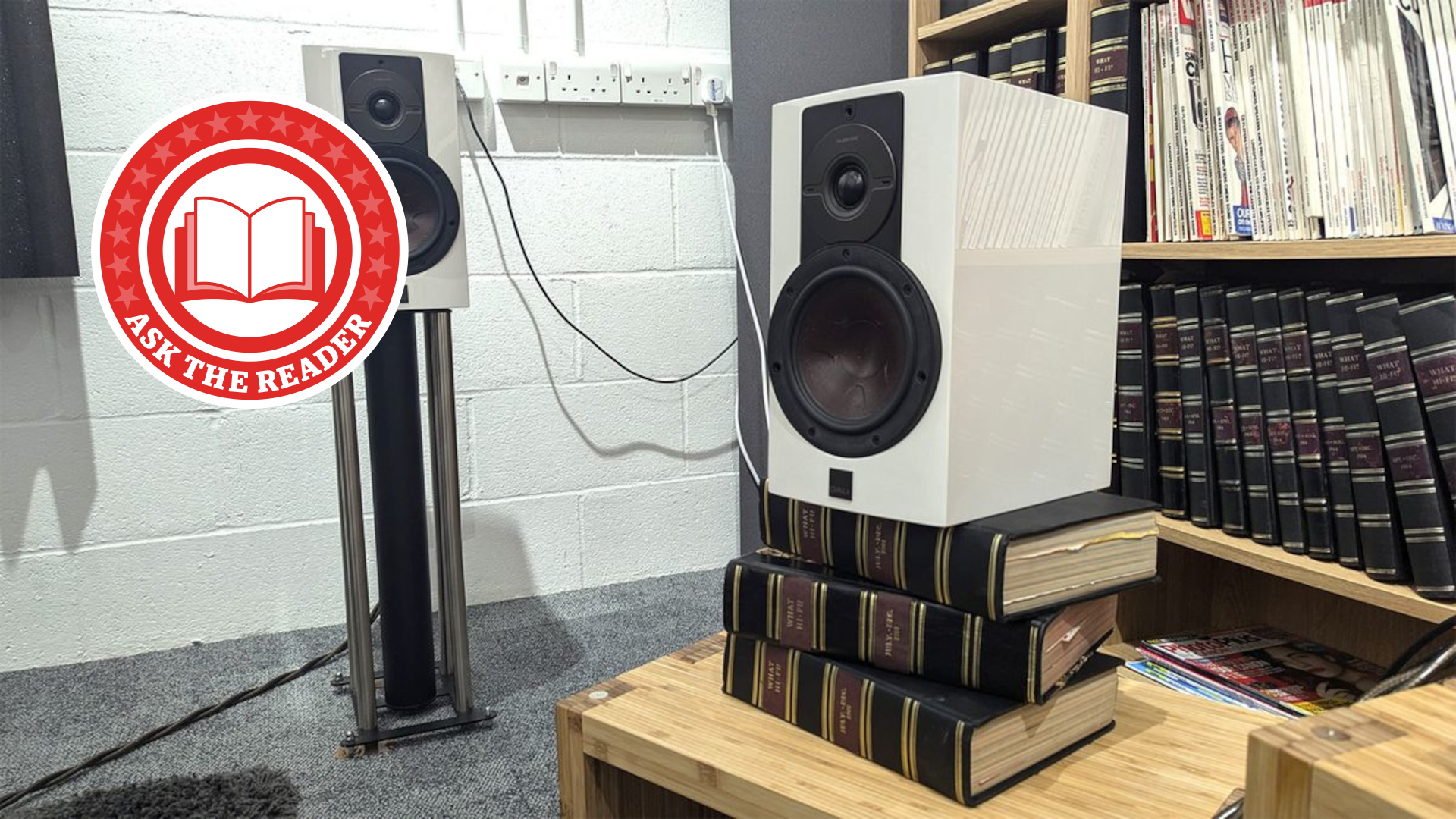 Speaker stacked on boos with Ask the Reader logo