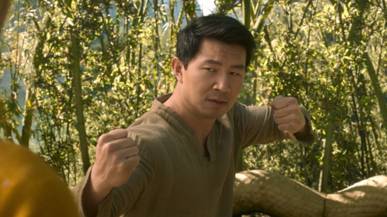 Simu Liu with fists raised to fight in Shang-Chi and the Legend of the Ten Rings