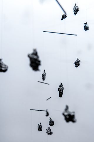 hanging mobile made of meteorite stones