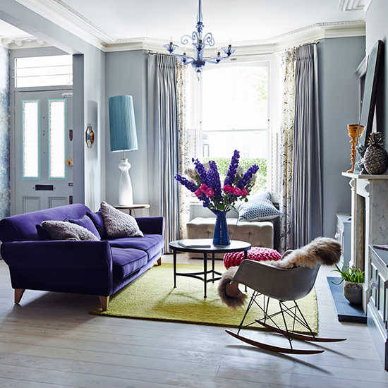 living room with sofa cushions window chandelier and coffee table