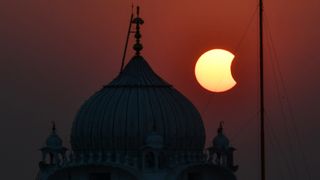 The moon partially obscures the sun during a partial solar eclipse visible from Patna, India, on October 25, 2022. (Photo by Sachin KUMAR / AFP) (Photo by SACHIN KUMAR/AFP via Getty Images)